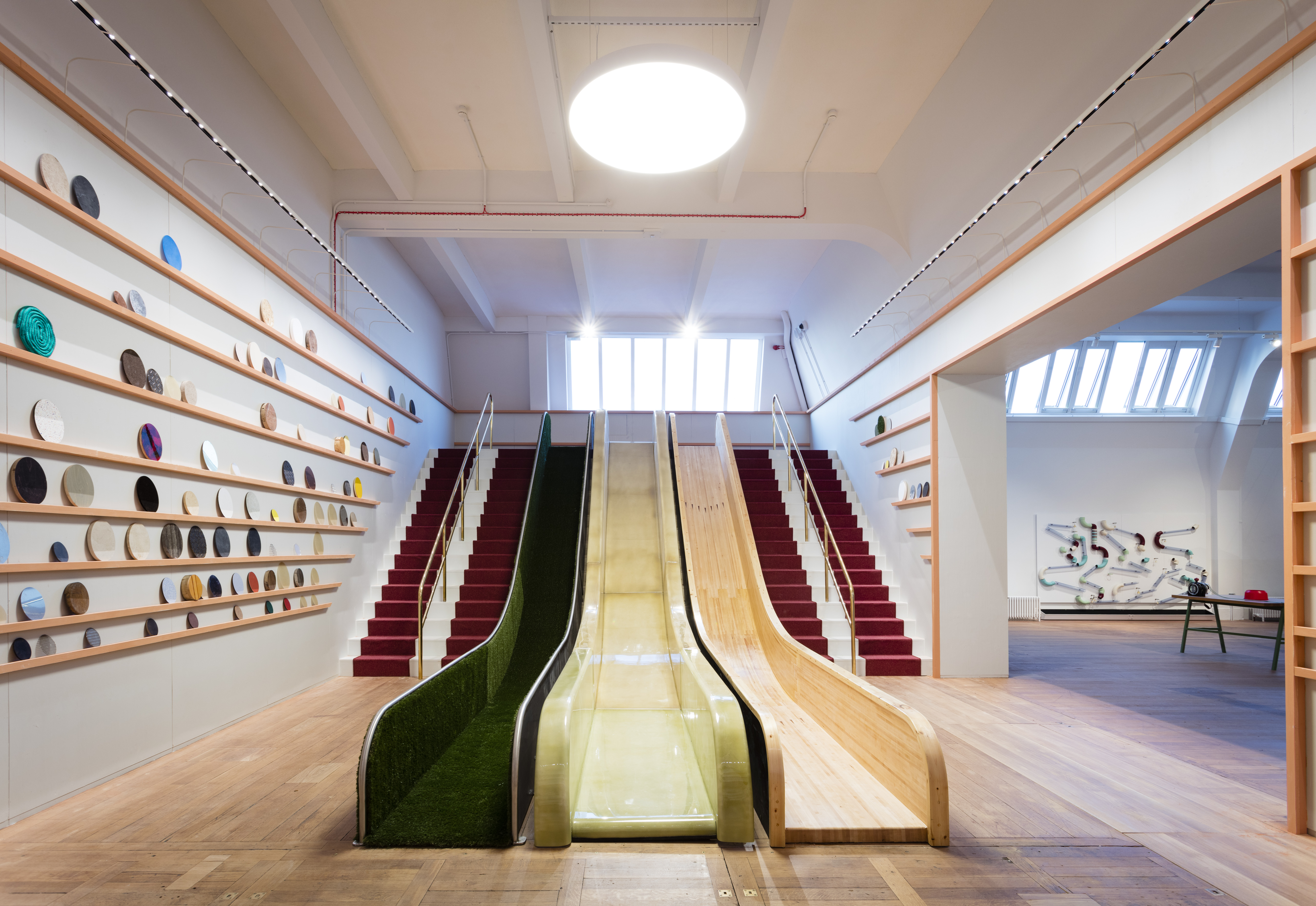 A photo of Wonderlab's friction slide with three lanes, each made of a different material.