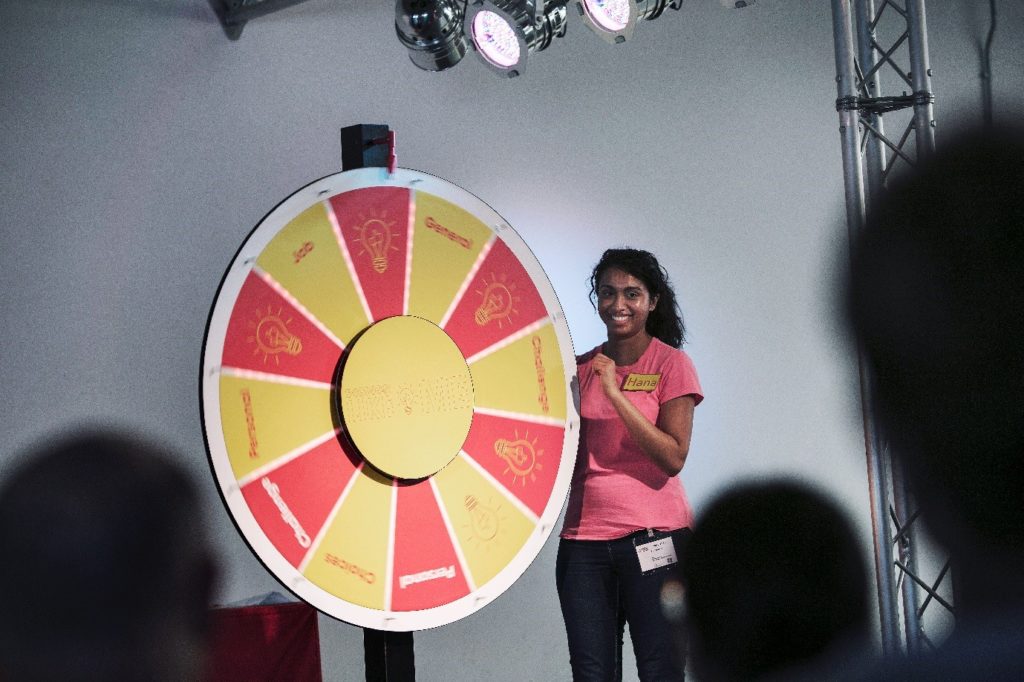 A presenter spinning the Engineer Like Me gameshow wheel.