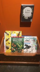 Box of children's books and the ‘I-spy nature’ activity leaflet.