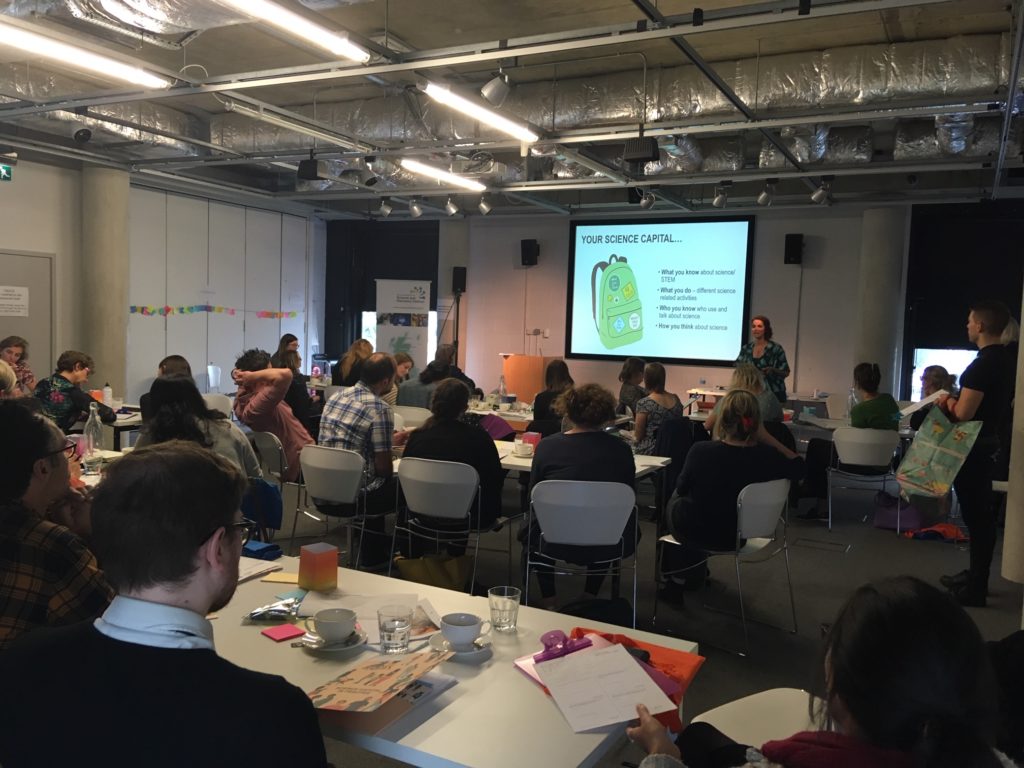 Participants at tables finding out about their science capital.