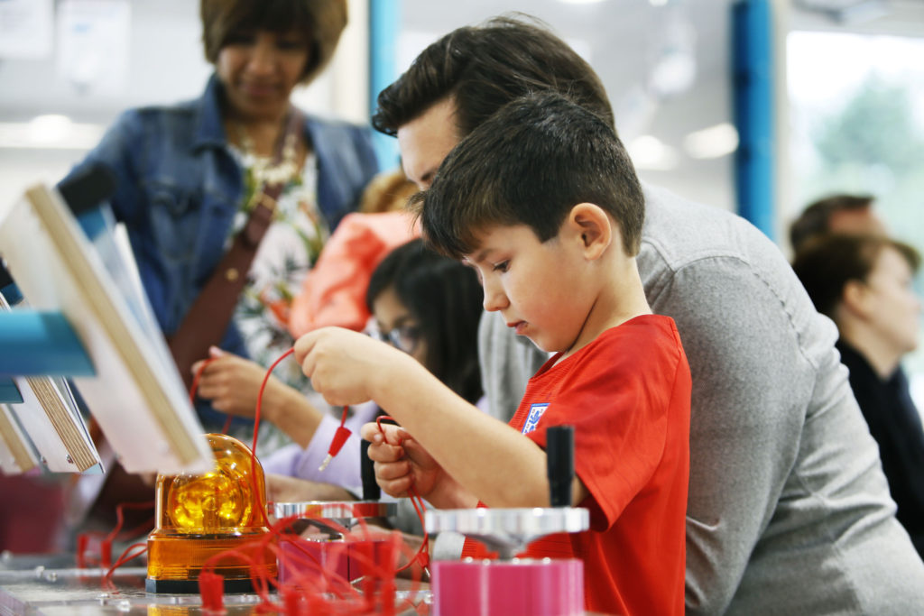 Family groups engaged in electrical circuits problem solving at the Science Oxford Centre
