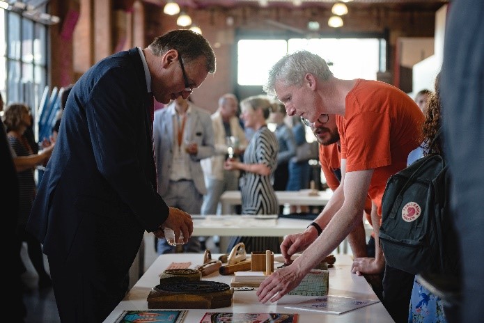 Visitors in the 'Conversation Space' interacting with a collection of handling objects.