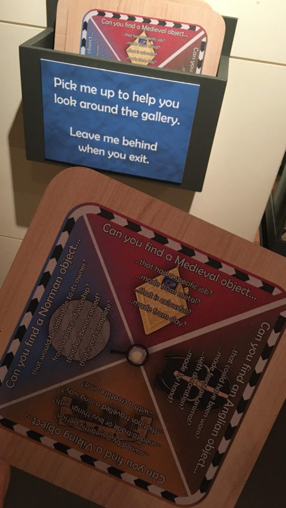 Tactile wooden activity plaque that visitors can take with them around the exhibition, providing questions to hunt for different objects.