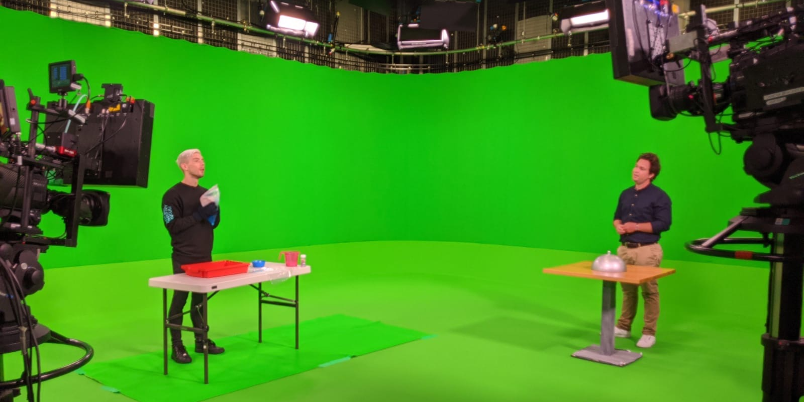 Maxwell Hamilton being filmed in front of a green screen demoing one of our hands-on activities with Sam Nixon in the BBC studios.