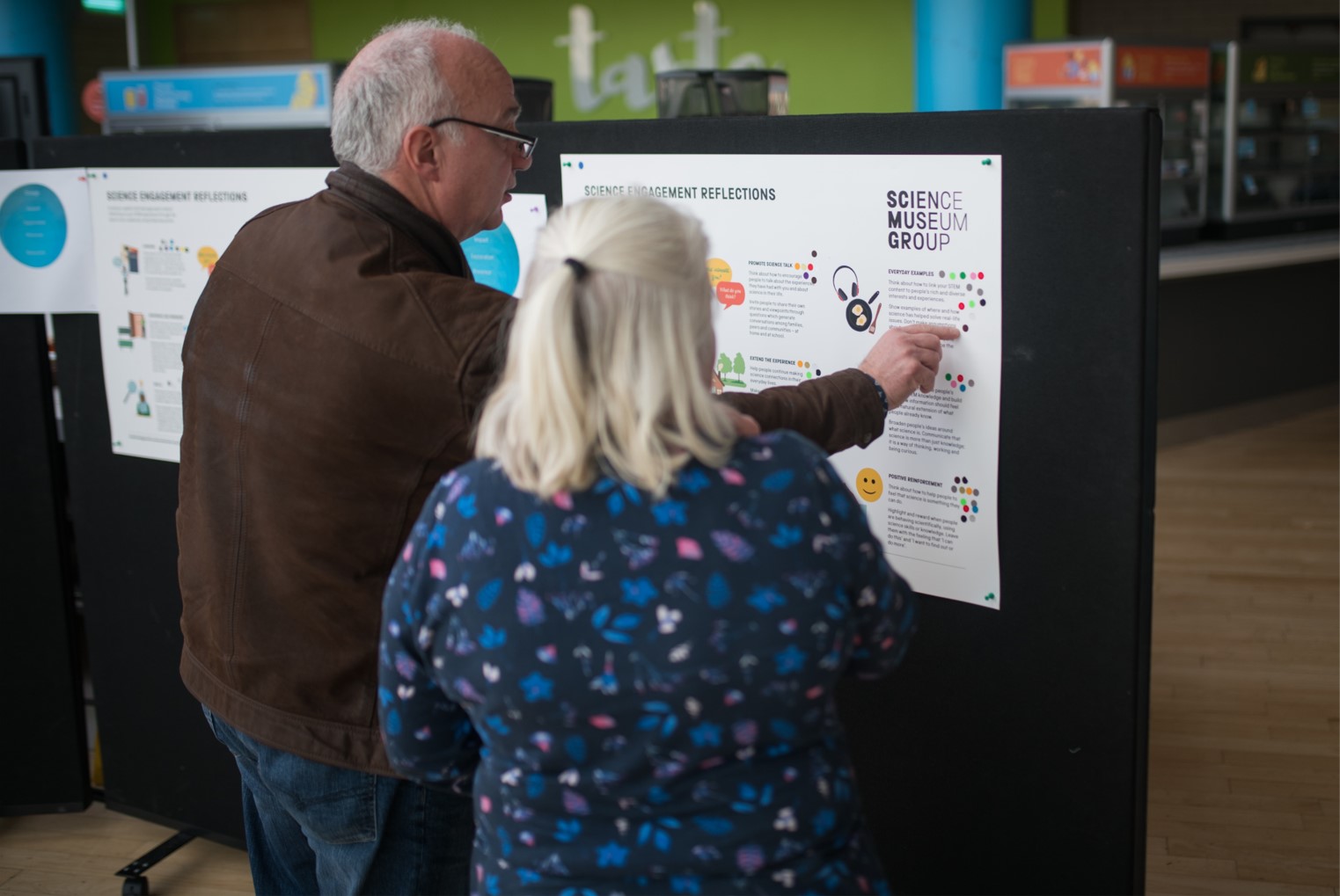 Staff and volunteers reading and voting on the engagement reflection points at Glasgow Science Centre