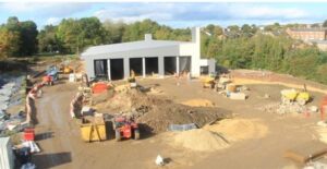 A construction site with a grey shell of a building.